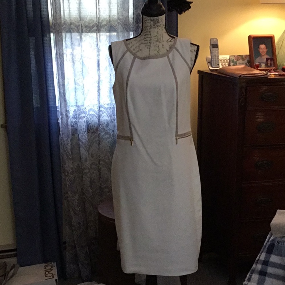 Calvin Klein off white with snake skin trim and matching zip up jacket.